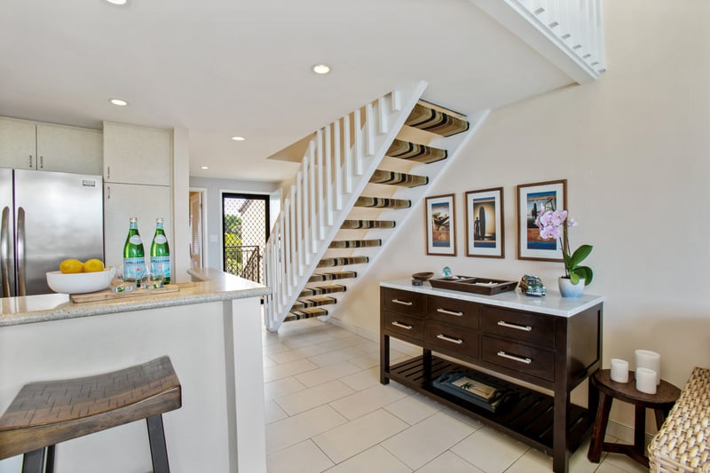Enjoy cooking in this bright, modern kitchen with stainless steel appliances, sleek stone counters, and soft lighting