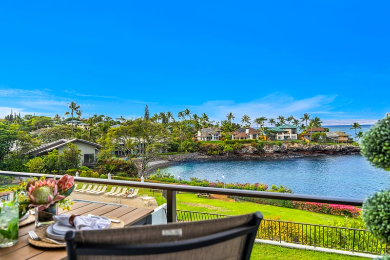 Enjoy an easy outdoor setup on the lanai with ocean views framed by tropical landscaping and the sound of the surf nearby.