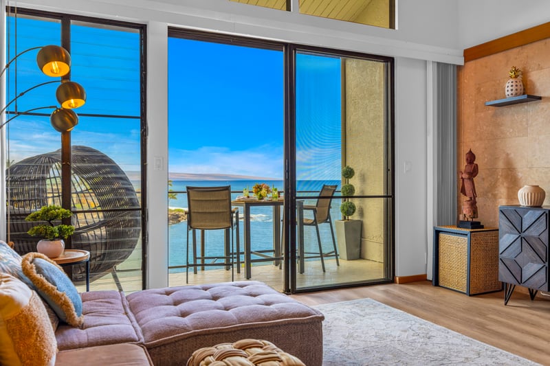 Put your feet up in the living room with vaulted ceilings and ocean views through wide glass doors to the lanai.