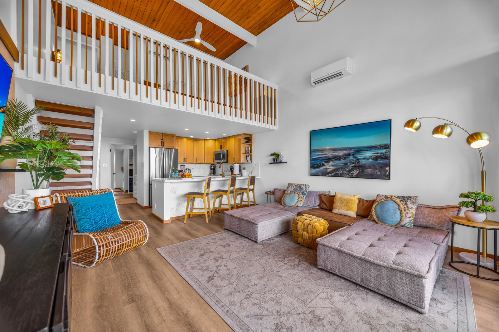 This angle highlights the soaring ceilings and loft railing, giving the main living space a breezy, spacious feel. NAP-C32