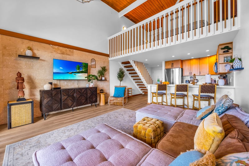 Look up to the loft-style balcony and vaulted ceilings, a striking architectural touch that keeps the living space airy.