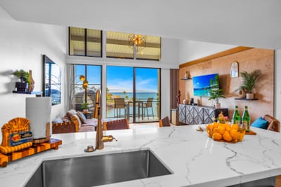 A wide kitchen view shows generous counter space and a clean layout, great for quick breakfasts before a beach day.