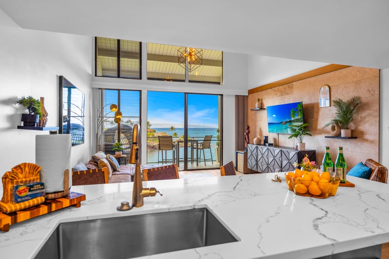 A wide kitchen view shows generous counter space and a clean layout, great for quick breakfasts before a beach day.