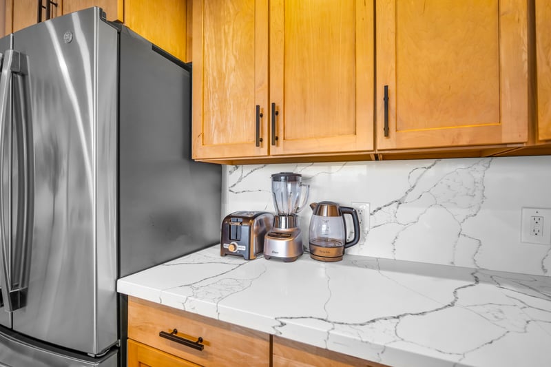 The kitchen island offers plenty of workspace, perfect for slicing fresh fruit or laying out snacks for the day.
