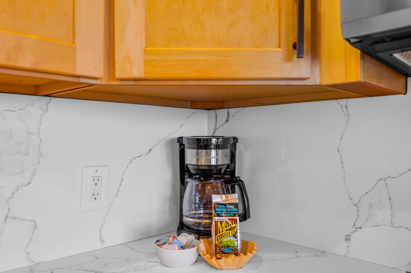 Enjoy a tidy cooking setup with modern appliances and ample cabinetry, ready for anything from coffee to full dinners.