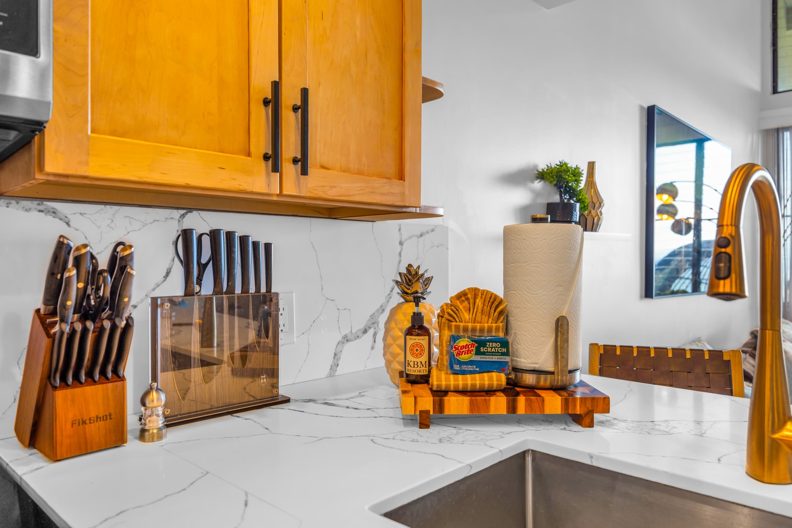 The kitchen opens to the main living space, so you can chat, pour drinks, and plate meals without missing the view. NAP-C32