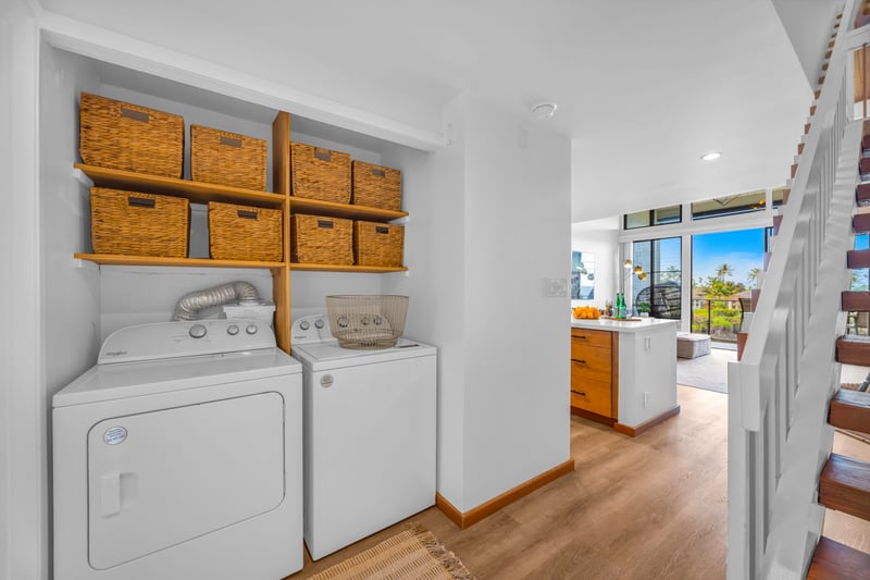 A second laundry view shows the convenient in-unit washer and dryer, great for swimsuits and beach towels mid-stay.