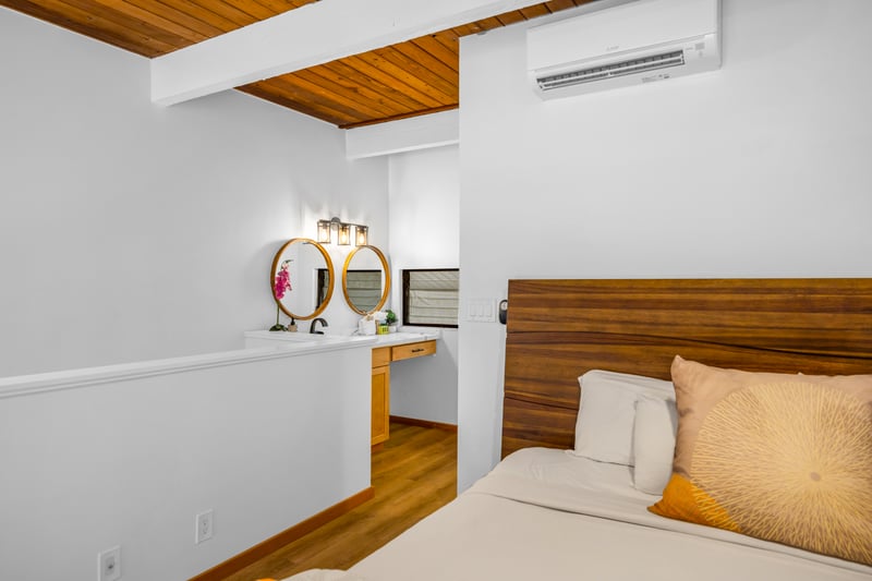 Another angle shows the guest room’s vaulted ceiling and calm design, perfect for quiet mornings before the beach.