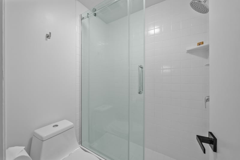 Step into the guest bath with a glass shower enclosure and clean, modern look for a quick refresh anytime.