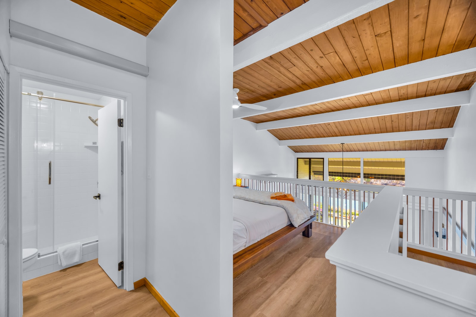 The guest room setup stays light and airy under the wood ceiling, a peaceful spot for afternoon downtime. NAP-C32