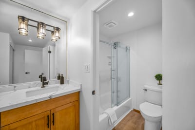 Refresh in the primary bath with a clean vanity area and bright lighting that makes getting ready quick and easy.