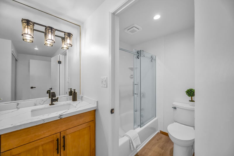 Refresh in the primary bath with a clean vanity area and bright lighting that makes getting ready quick and easy.