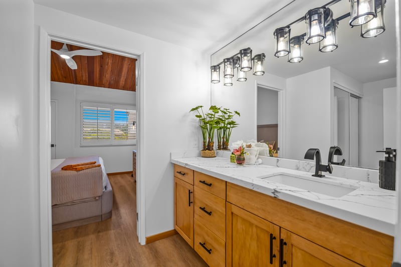 The primary bath features a sleek shower area and crisp finishes, ideal for rinsing off after sand and saltwater.