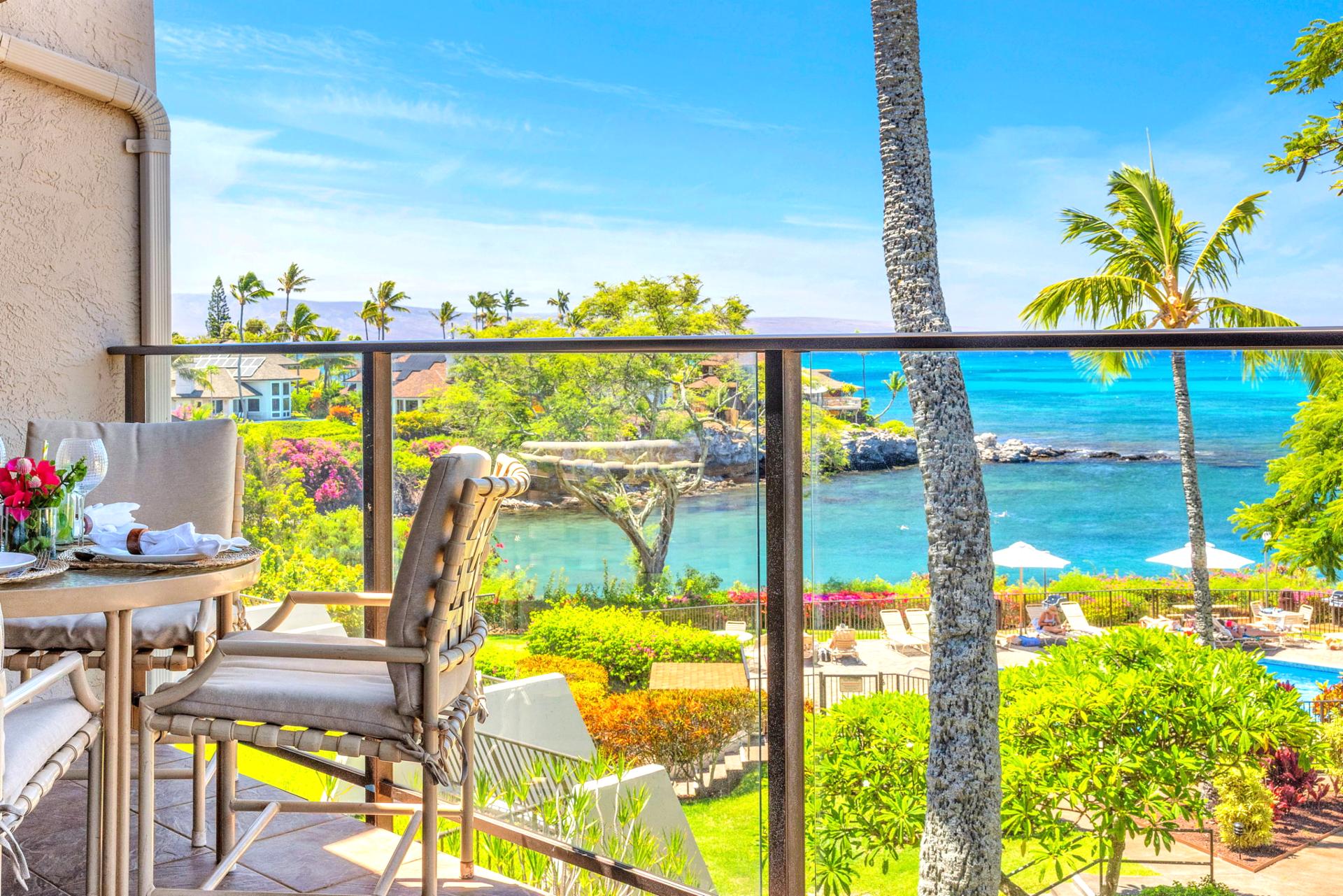 Oceanfront lanai with outdoor dining and panoramic views of turquoise waters, lush gardens, and the pool below — perfect for a tropical escape. NAP-C37