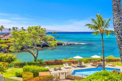 Breathtaking ocean view with turquoise waters, lush tropical landscaping, and a sparkling pool — the ultimate Hawaiian getaway setting. NAP-C37