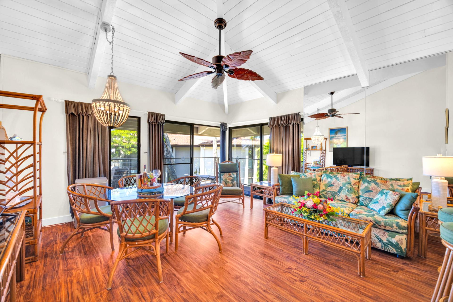 Expansive great room with vaulted ceilings, natural light, and tropical rattan furnishings—designed for comfort and conversation. NAP-C37