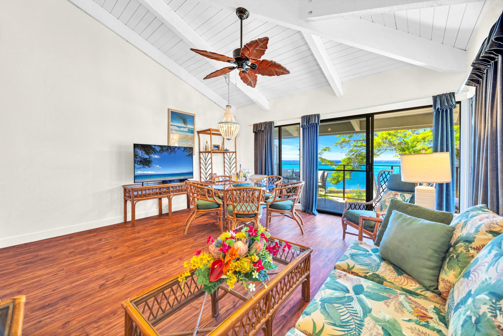 Spacious, vaulted-ceiling living room with tropical flair and wall-to-wall ocean views for the ultimate island retreat. NAP-C37