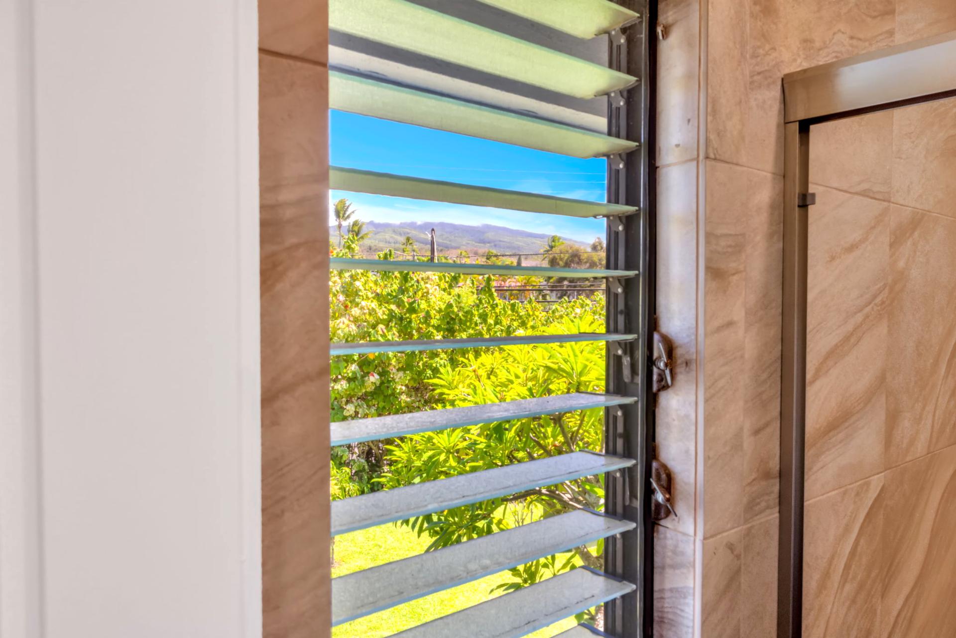 Tropical greenery and mountain views from the bathroom window—bringing Maui’s beauty into every corner of your stay.