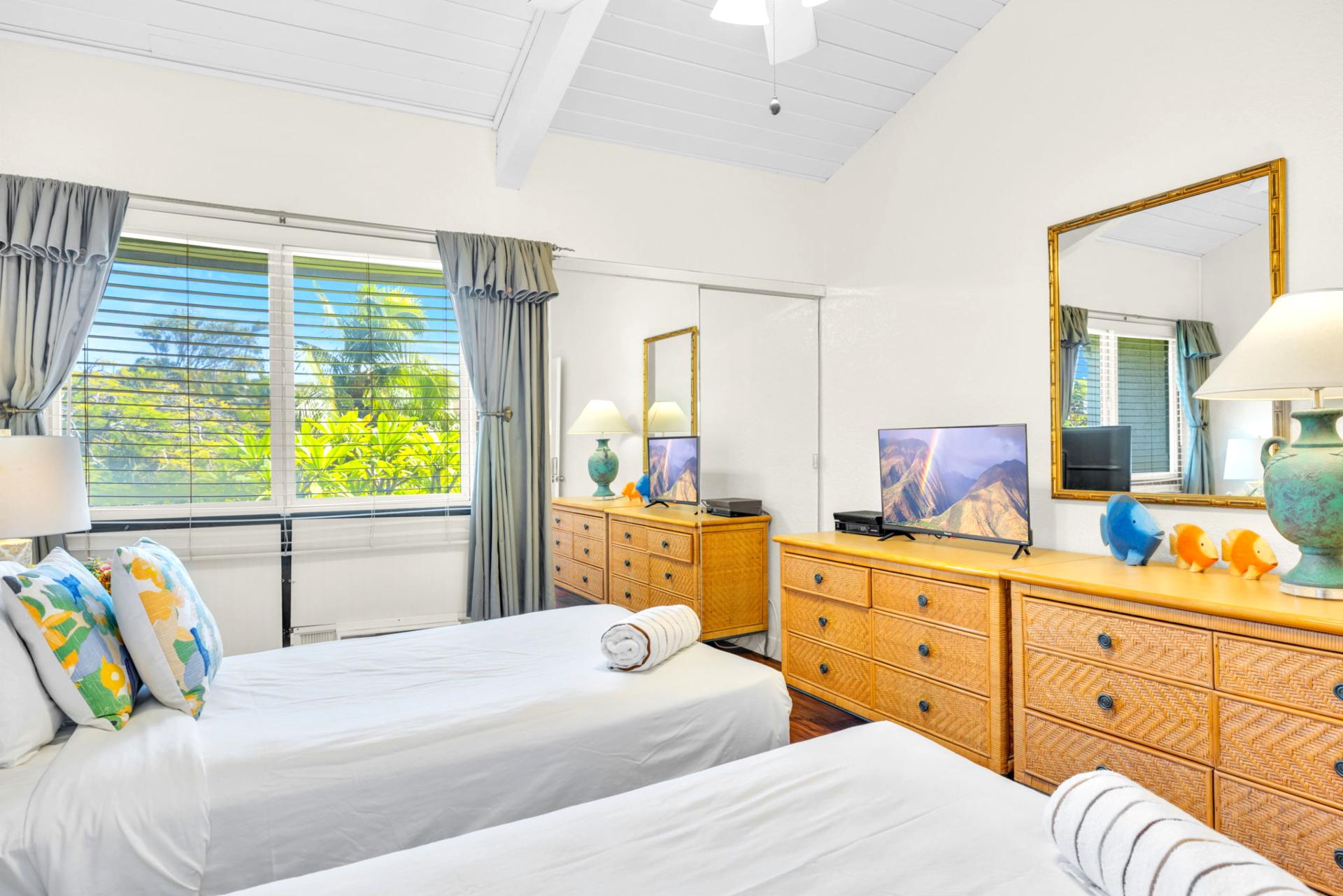 Spacious guest bedroom with twin beds, large dresser storage, and a flat-screen TV for added comfort. NAP-C37