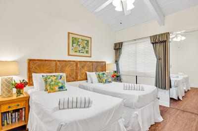 Cheerful second bedroom with twin beds, vaulted ceiling, and plenty of natural light—perfect for family or friends." NAP-C37