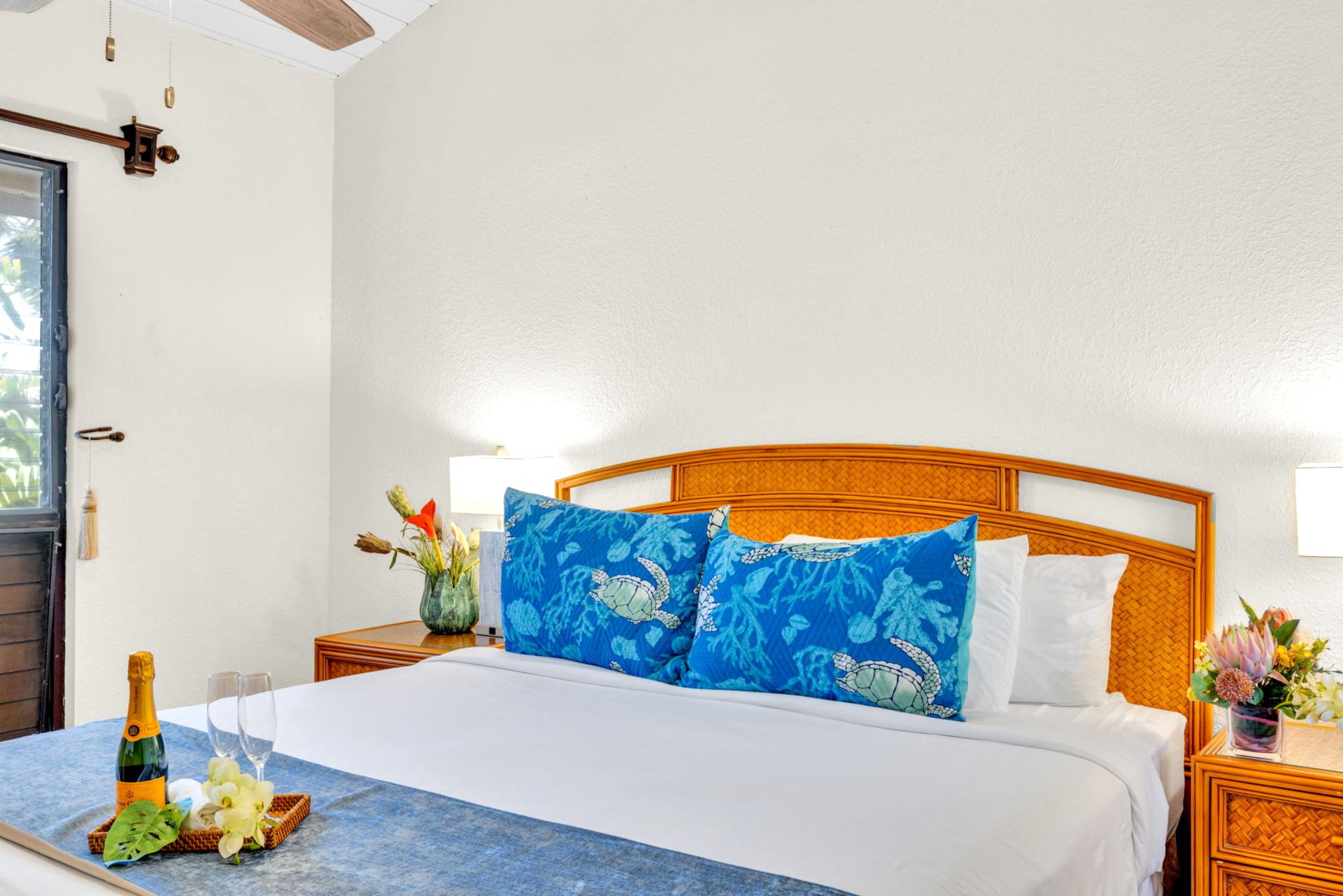 Bright, inviting bedroom with tropical accents and cozy linens for a restful night’s sleep. NAP-C37