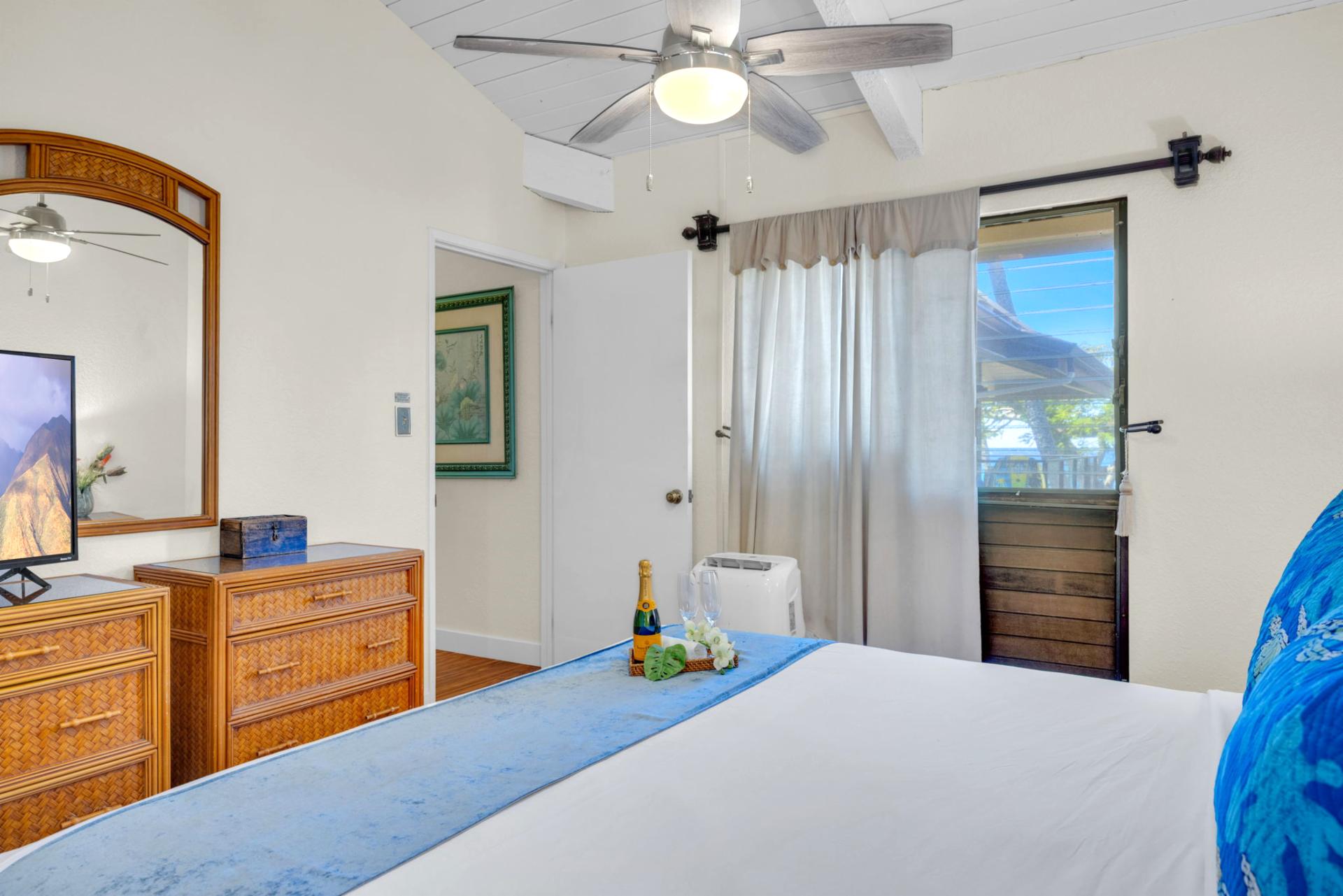 Peaceful bedroom with private lanai access—wake up to island breezes and morning sunlight. NAP-C37