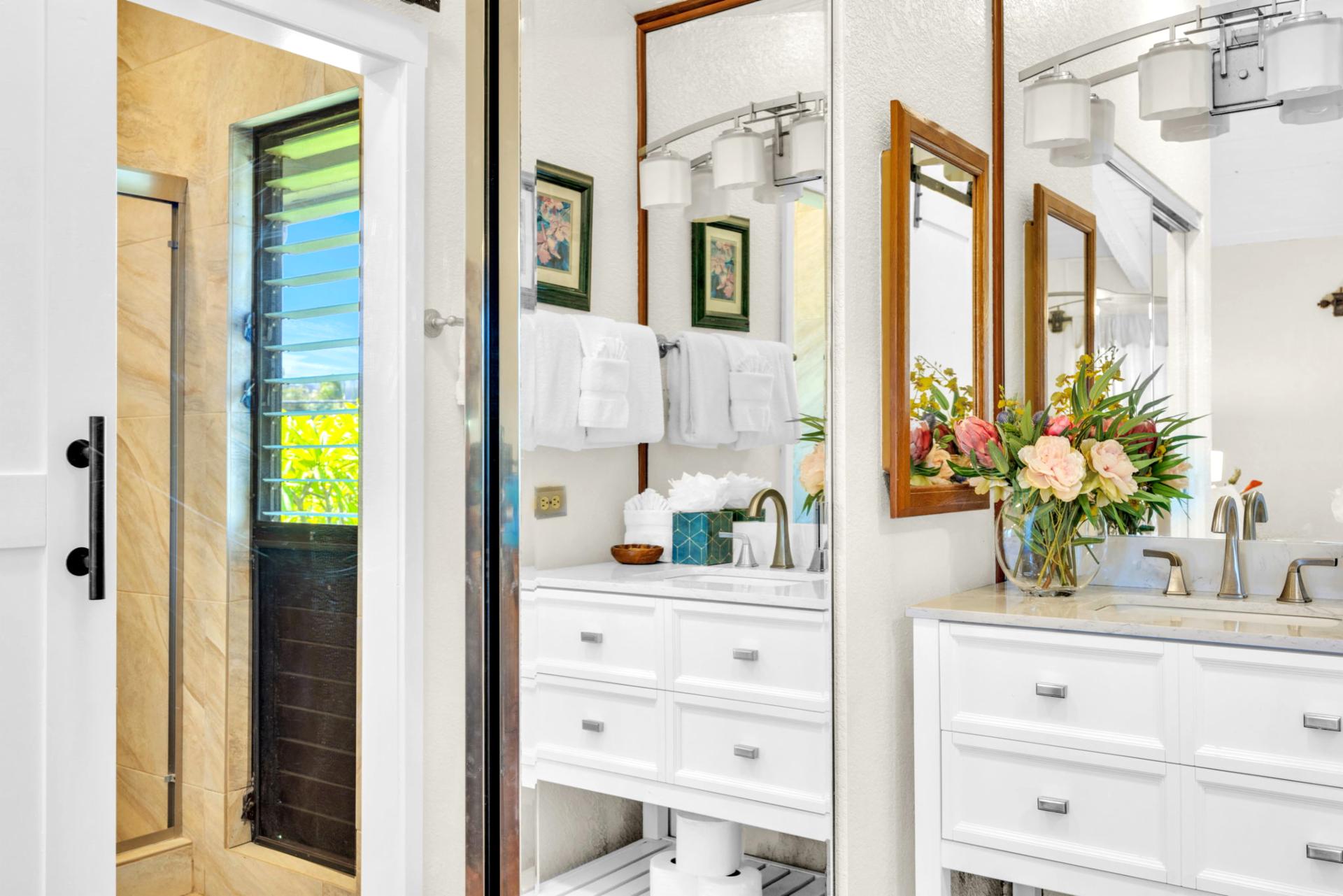 Bright ensuite bath with modern vanities, elegant fixtures, and walk-in shower for a spa-like retreat. NAP-C37