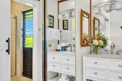 Bright ensuite bath with modern vanities, elegant fixtures, and walk-in shower for a spa-like retreat. NAP-C37