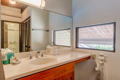 A pristine combination of white tile and frosted glass transforms this shower-bath combo into a clean, calming retreat