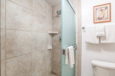 Crisp white tile and a frosted glass enclosure create a timeless shower experience wrapped in light and peaceful privac NAP-C42