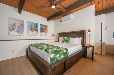 Cozy yet airy, this loft retreat features warm wood tones, lush bedding, and cheerful tropical-inspired decor