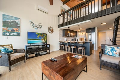 Kick back under lofted ceilings surrounded by tropical art, woven accents, and a sleek, beach-ready kitchenette