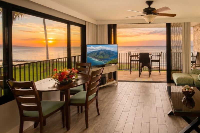 Indoor dining for three, framed by oceanfront windows, bringing Maui's beauty indoors.
