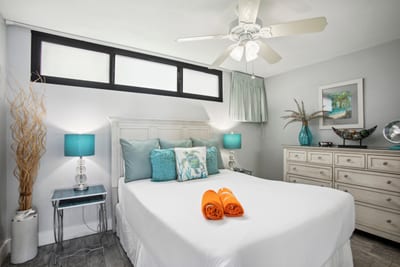 Primary bedroom with a King bed, ceiling fan, and coastal accents for a peaceful night’s sleep.