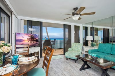 Spacious living and dining area framed by oceanfront windows, bringing Maui's beauty indoors.