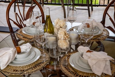 Enjoy breezy balcony meals on stylish rattan seating, with soft lighting, lush views, and a polished island vibe