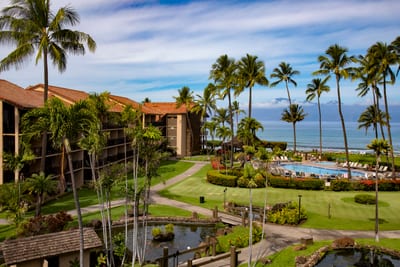 Clouds kiss the mountains, palms sway in rhythm, and your perfect Maui day unfolds by the pool and sea