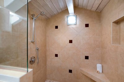 The walk-in shower and dual-sink vanity are framed by soft light and craftsmanship, creating a peaceful daily escape