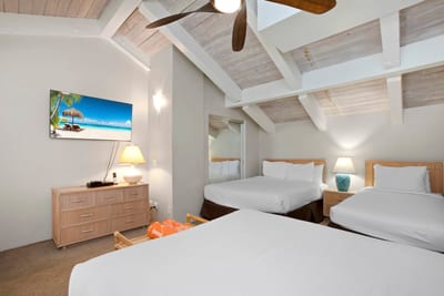 Tucked beneath airy beams, this loft offers three cloud-soft beds for the ultimate shared retreat