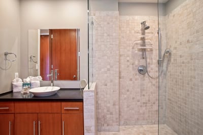 Every detail—from the floating glass shower to the warm textures—reflects elevated taste and quiet indulgence