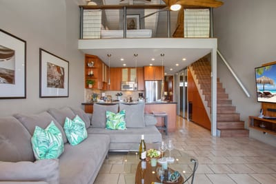 This open-concept living room blends playful coastal touches with lofty elegance and warm island hospitality