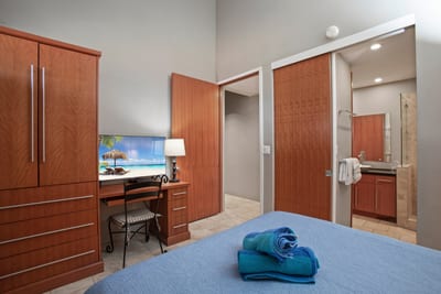 Tucked beside the bed, a charming desk invites you to unwind, journal, or plan your next Maui day