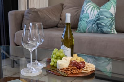Linger over wine and charcuterie or watch the palms sway—this living room was made for slow, sunlit moments