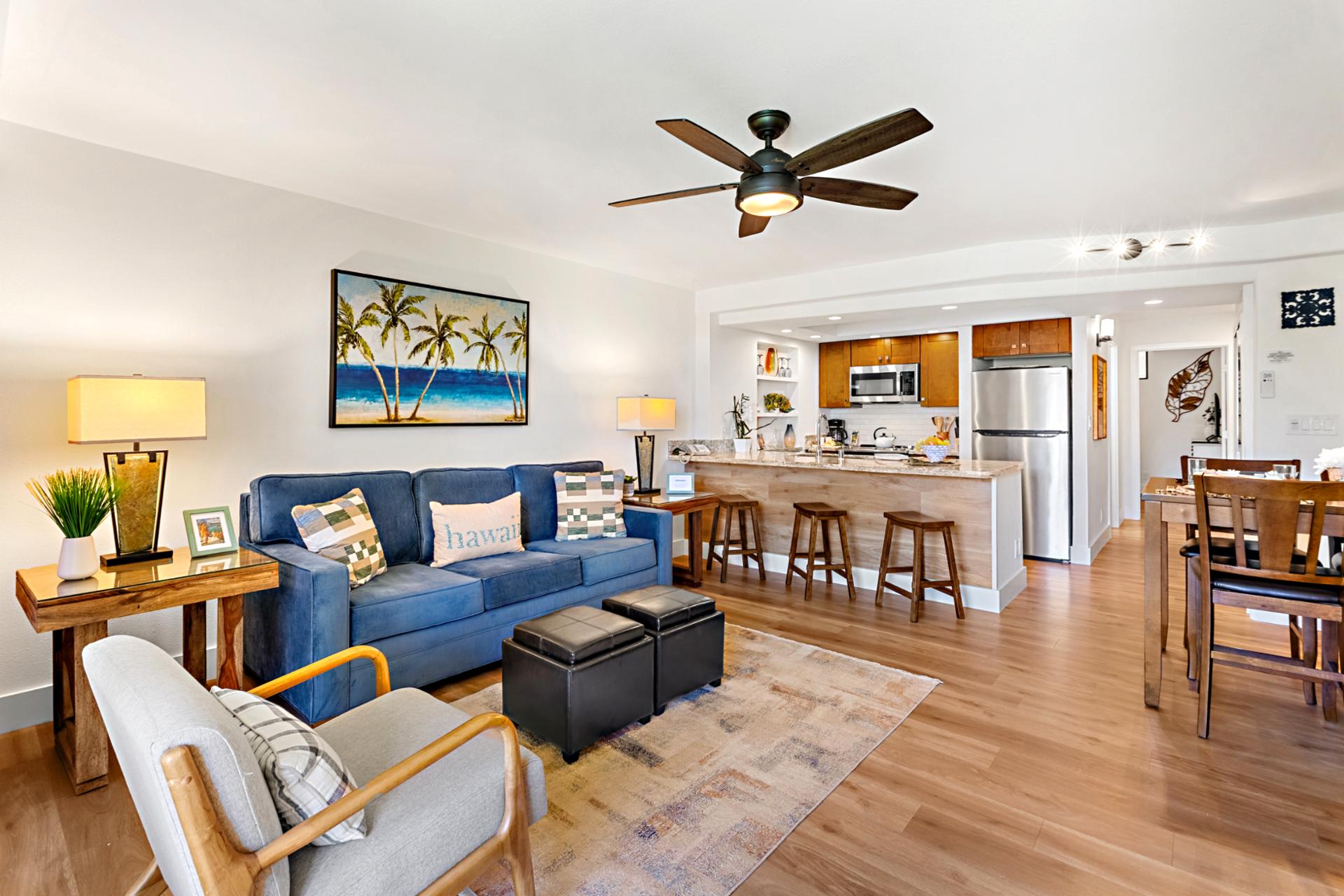 Gather in your open concept living area with plush seating, ceiling fan, and direct access to your private ground floor lanai.