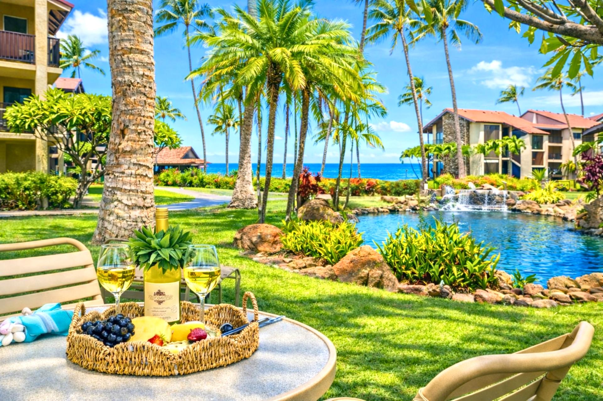 Lush oceanfront lawn at Papakea Resort invites you to lounge steps from the Pacific, with palms, koi ponds, and sunset views just beyond.