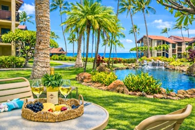 Lush oceanfront lawn at Papakea Resort invites you to lounge steps from the Pacific, with palms, koi ponds, and sunset views just beyond. PKD-104