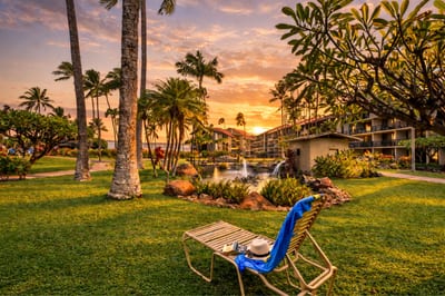 Golden hour settles over Papakea’s beachfront grounds, where you can stroll across manicured lawns toward the ocean as the sky glows in warm island light. PKD-104