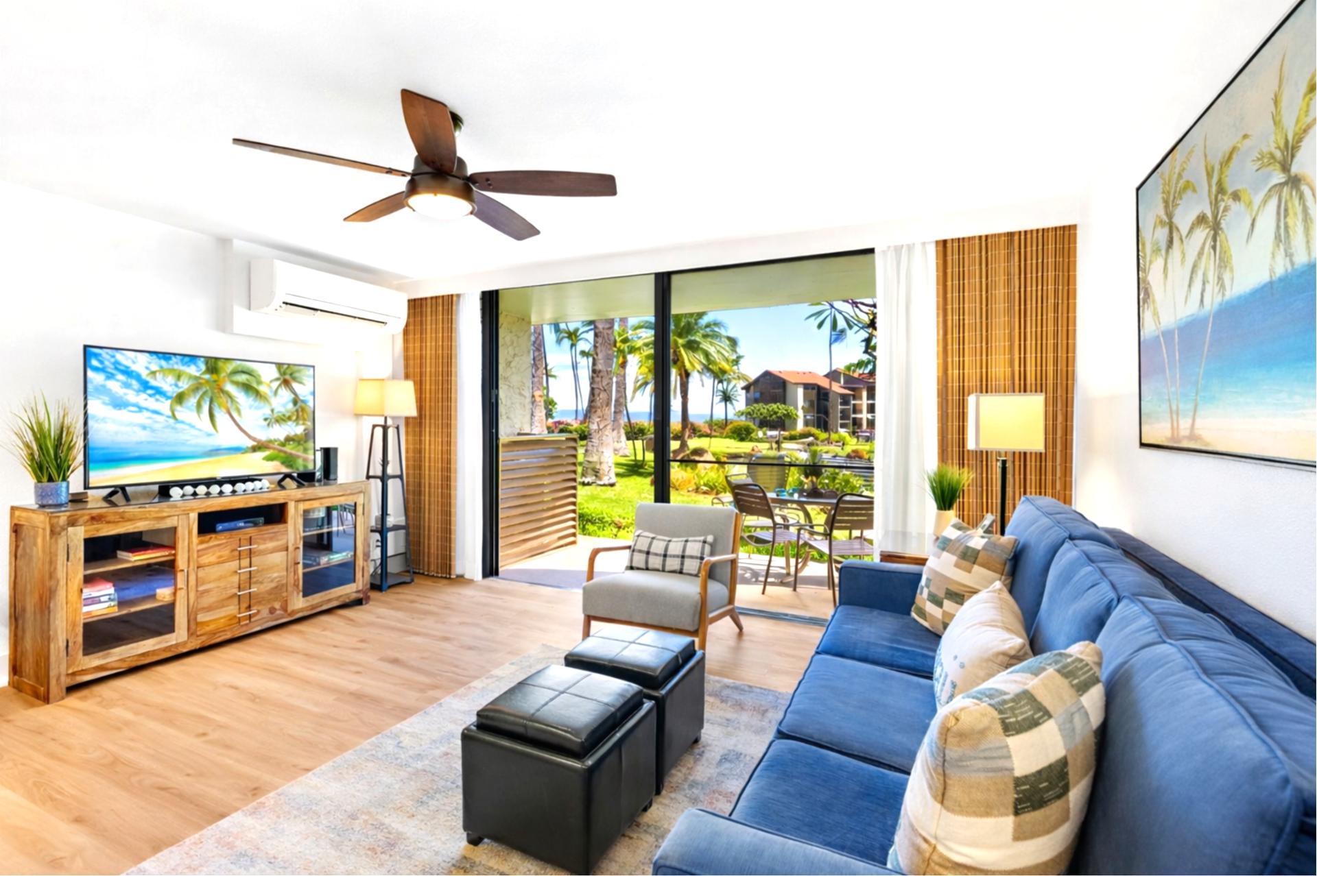 From your living room, sliding glass doors open to tropical views, filling your space with natural light and seamless indoor outdoor flow.