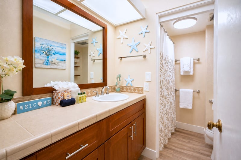 The bathroom offers a bright, functional space to prepare for beach days, sunset dinners, and everything in between