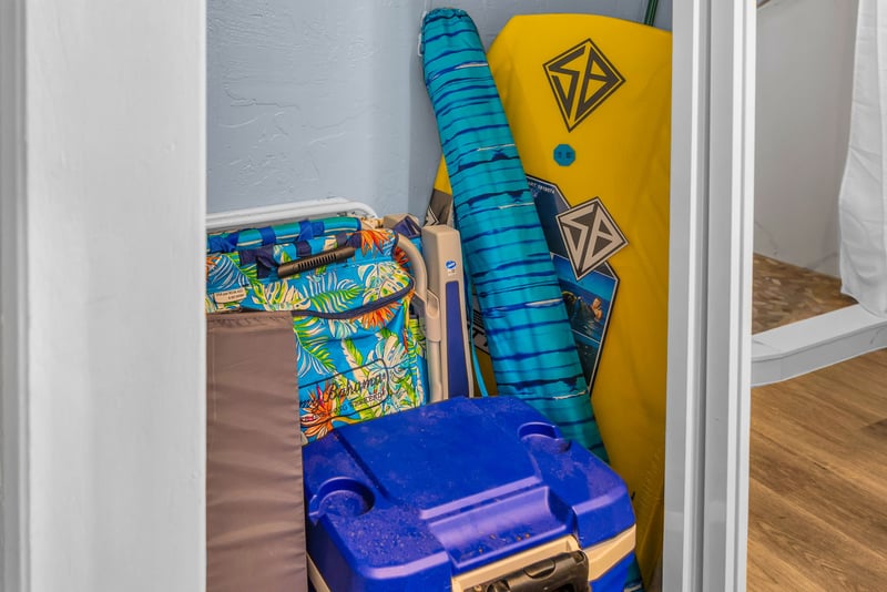 The storage closet holds boogie boards, a cooler, and beach chairs for your use